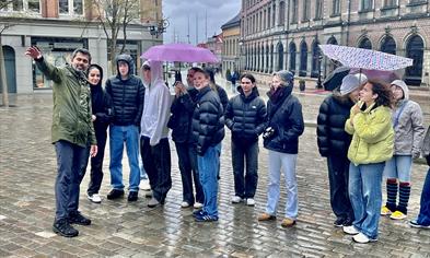 Young visitors listen to the strange tales of Bergen. Vågsallmenningen