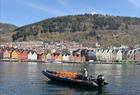 Rib boat with Bryggen in Bergen in the background