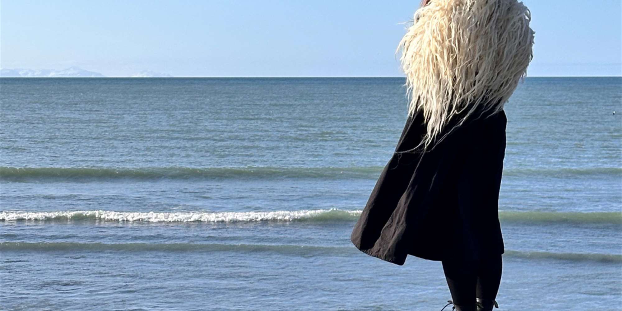 Dressed in a varafell, looking over the sea Dressed in a varafell, looking over the sea